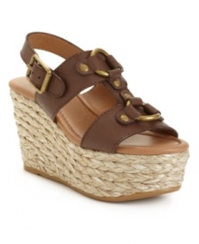 Show off with Lucky Brand's reinterpretation of a classic wedge: the Reba. Metal hardware adorns the chunky straps set atop a unique rattan-covered platform. Show off with Lucky Brand's reinterpretation of a classic wedge: the Reba. Metal hardware adorns the chunky straps set atop a unique rattan-covered platform.
