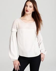 Soft touches of lace romance your fall wardrobe, proven by this Madison Marcus top, flaunting feminine bell sleeves for a beautiful, boho look.