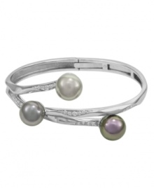 Ocean-inspired style. Embellish your wrist with this coral-like bangle by Majorica. Set in sterling silver, three soft-hued organic man-made pearls (12 mm) are accentuated by cubic zirconia details. Approximate diameter: 2-1/2 inches.