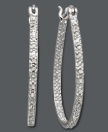 Dazzling hoops fit for a diva. Victoria Townsend adds glam to these oval-shaped hoops with dozens of round-cut diamonds (1/4 ct. t.w.). Set in sterling silver. Approximate diameter: 1-3/10 inches. Dazzling hoops fit for a diva. Victoria Townsend adds glam to these oval-shaped hoops with dozens of round-cut diamonds (1/4 ct. t.w.). Set in sterling silver. Approximate diameter: 1-3/10 inches.