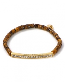 Follow your feline instincts and flaunt MICHAEL Michael Kors' tiger's eye bracelet--the fierce wristpiece lends exotic flair to staple tees or femme blouses. Follow your feline instincts and flaunt MICHAEL Michael Kors' tiger's eye bracelet--the fierce wristpiece lends exotic flair to staple tees or femme blouses.