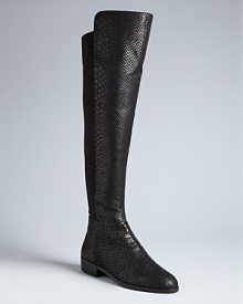 Python-embossed leather lends sensual appeal to these long, tall MICHAEL Michael Kors boots. Stretch backs make them sleekly, perfectly fitting: Snake it up. Python-embossed leather lends sensual appeal to these long, tall MICHAEL Michael Kors boots. Stretch backs make them sleekly, perfectly fitting: Snake it up.