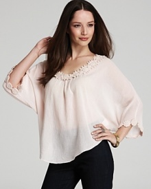 Intricate crochet glorifies a diaphanous XCVI tunic for pure ethereal elegance. Play up the blush-worthy hue with layered neutrals for a subtle statement. Intricate crochet glorifies a diaphanous XCVI tunic for pure ethereal elegance. Play up the blush-worthy hue with layered neutrals for a subtle statement.