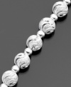 This distinctive bracelet features beautifully swirled beads (6 mm) of luminous diamond-cut sterling silver by Giani Bernini. Approximate length: 7-1/2 inches.