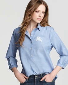 A washed blue cotton takes to a breezy silhouette for a well-worn take on your favorite Burberry Brit shirt. Pair with white denim for easy summertime style. A washed blue cotton takes to a breezy silhouette for a well-worn take on your favorite Burberry Brit shirt. Pair with white denim for easy summertime style.