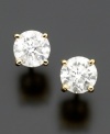 Simply spectacular. Round-cut diamond (1/5 ct. t.w.) takes center stage on these stud earrings set in 14k gold.