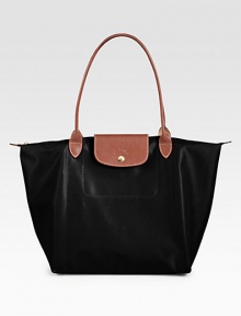 Lightweight nylon finished with rich leather trim, great for travel and everyday use.Double top handles, 8¼ dropTop zip and snap flap closureFolds up and snaps closedOne inside open pocket12¼W X 11¾H X 7½DImported Lightweight nylon finished with rich leather trim, great for travel and everyday use.Double top handles, 8¼ dropTop zip and snap flap closureFolds up and snaps closedOne inside open pocket12¼W X 11¾H X 7½DImported