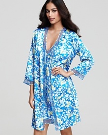 Exude elegance in an allover floral print wrap with intricate mesh trim. Exude elegance in an allover floral print wrap with intricate mesh trim.