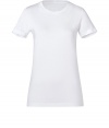 This tee made of fine, white cotton is a closet essential - Wonderfully soft and comfortable on the skin - Narrow-waisted silhouette, with round neck and short sleeves - Long cut - Great for the office as a layering piece, or on the weekends with jeans, skirts or leggings