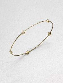 From the Regitze Gold Collection. A slender gold bangle is stationed with five bezel-set, brilliant-cut diamonds in this design of quiet dazzle.Diamonds, .20 tcw18k yellow gold Diameter, about 2½Imported From the Regitze Gold Collection. A slender gold bangle is stationed with five bezel-set, brilliant-cut diamonds in this design of quiet dazzle.Diamonds, .20 tcw18k yellow gold Diameter, about 2½Imported