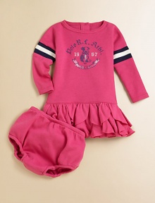 This playful ruffled dress combines a classic waffle-knit design and plush cotton for an athletic-inspired style.CrewneckLong dolman sleevesBack buttonsDrop-waistRuffled hemCottonMachine washImported Please note: Number of buttons may vary depending on size ordered. 