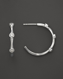 Three faceted diamonds sparkle from 18K white gold hoops from Roberto Coin. Three faceted diamonds sparkle from 18K white gold hoops from Roberto Coin.