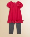 Sweet bows, sequins and ruffles adorn this adorable sweater tunic and leggings set.  Tunic Ribbed roundneckShort puff sleevesBow and sequin accentsRuffled hemBack keyhole with button closure Leggings Elastic waistbandPull-on styleTunic: cotton/acrylicLeggings: cotton/spandexMachine washImported