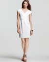 DKNY's trend-right white dress flatters the figure with a ladylike silhouette. Strappy wedges complete for summer-perfect style.