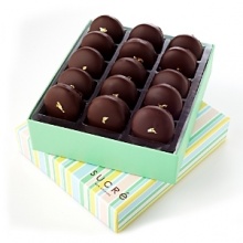 French Macaroons filled with milk chocolate caramel ganache, coated in dark chocolate and topped with gold leaf. French Macaroons filled with milk chocolate caramel ganache, coated in dark chocolate and topped with gold leaf.