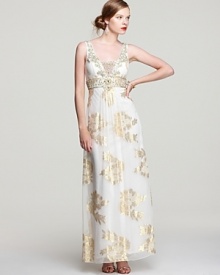 Exuding sophisticated glamour, Sue Wong's metallic detailed gown makes a statement with elaborate, beaded details. Exuding sophisticated glamour, Sue Wong's metallic detailed gown makes a statement with elaborate, beaded details.