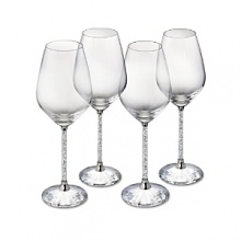 Hundreds of crystals sparkle on the stems of these glittering white wine glasses, while a faceted crystal base reflects light. From Swarovski. Hundreds of crystals sparkle on the stems of these glittering white wine glasses, while a faceted crystal base reflects light. From Swarovski.