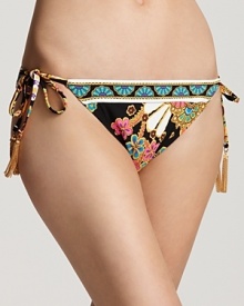 Lap them in Trina Turk's eye-catching print. Trimmed in gold tassels, this side-tie bottom adds an on-trend splash whether peeking from beneath a tunic or pair of gauzy pants. Lap them in Trina Turk's eye-catching print. Trimmed in gold tassels, this side-tie bottom adds an on-trend splash whether peeking from beneath a tunic or pair of gauzy pants.