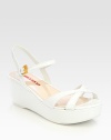Patent leather wedge style with criss-cross detail and adjustable ankle strap. Self-covered wedge, 2½ (65mm)Covered platform, 1 (25mm)Compares to a 1½ heel (40mm)Leather upperLeather liningRubber solePadded insoleImportedOUR FIT MODEL RECOMMENDS ordering true size. 
