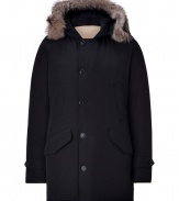 Designed by Yoshida Tokihito as a modern interpretation of the forever favorite Arctic parka, Woolrichs Polar parka is a must for contemporary cool weather looks - Hood with coyote fur trim, long sleeves, buttoned tabbed cuffs, hidden two-way front zip, button placket, buttoned front flap and slit pockets, tonal elbow patch detail - Contemporary fit, slightly fitted waist - A versatile, classic coat perfect for both city streets and country slopes