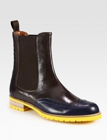 Easy-to-wear rainy weather staple of bicolor leather with wingtip detailing and a vibrant rubber sole. Stacked rubber and wooden heel, 1¼ (30mm)Leather upperBack pull-tab and side elastic goresLeather liningRubber trek solePadded insoleMade in ItalyOUR FIT MODEL RECOMMENDS ordering one half size up as this style runs small. Easy-to-wear rainy weather staple of bicolor leather with wingtip detailing and a vibrant rubber sole. Stacked rubber and wooden heel, 1¼ (30mm)Leather upperBack pull-tab and side elastic goresLeather liningRubber trek solePadded insoleMade in ItalyOUR FIT MODEL RECOMMENDS ordering one half size up as this style runs small.
