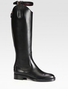 An equestrian-inspired bridle buckle tops this asymmetrical leather silhouette resting on a stacked heel. Stacked heel, 1¼ (30mm)Shaft, 17¼Leg circumference, 13Leather upperBack zip and adjustable leather strapLeather lining and solePadded insoleMade in ItalyThis style runs true to size. We recommend ordering your usual size for a standard fit. An equestrian-inspired bridle buckle tops this asymmetrical leather silhouette resting on a stacked heel. Stacked heel, 1¼ (30mm)Shaft, 17¼Leg circumference, 13Leather upperBack zip and adjustable leather strapLeather lining and solePadded insoleMade in ItalyThis style runs true to size. We recommend ordering your usual size for a standard fit.