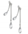 Drops of soothing crystals adorn these radiant earrings from Swarovski. Briolette-cut clear crystals shine on snake chains. Crafted in rhodium-plated mixed metal. Approximate drop: 2-1/2 inches.