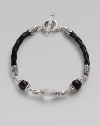 From the Iris Collection. From the carved frosted rock crystal bead to the smooth matte onyx beads and braided leather cord, this piece is a study in understated elegance. Sterling silver Toggle closure Length, about 7½ Imported 