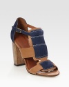 Smooth leather confection elevated by a rustic wooden heel, finished with suede trim and an adjustable ankle strap. Wooden heel, 4 (100mm)Leather and suede upperLeather lining and solePadded insoleImportedOUR FIT MODEL RECOMMENDS ordering true size. 