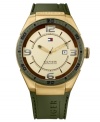 Masculine with bold color, this watch by Tommy Hilfiger keeps up with your busiest days. Crafted of olive green silicone strap and round gold tone stainless steel case. Olive green bezel features logo, black numerals and stick markers. Gold tone dial features green applied numerals at three, six, nine and twelve o'clock, stick indices, minute track, gold tone hour and minute hands, black second hand, date window at three o'clock and iconic flag logo at twelve o'clock. Quartz movement. Water resistant to 50 meters. Ten-year limited warranty.