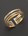 An elegant yellow gold cuff with scattered diamonds from Roberto Coin.