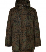 A stylish essential for transitional weather, this camouflage-covered parka will keep you looking cool from season-to-season - Stand-up collar with snaps, hood with adjustable drawstring, concealed zip front closure, long sleeves, cargo pockets, allover camo print - Loosely fitted - Wear with a cashmere pullover, straight leg jeans, and suede ankle boots