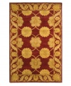 A golden vine-and-floral motif creates exquisite contrast against a deep maroon ground, adding fine finesse to this plush area rug from Safavieh. Tufted in India from pure wool, this rug evokes classic Persian designs in a bold, bright color palette for the contemporary home. (Clearance)
