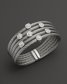 Diamonds set in white gold on a stainless steel bangle. By Charriol. Diamonds set in white gold on a stainless steel bangle. By Charriol.