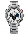 All-American and all-purpose, by Tommy Hilfiger. Watch crafted of stainless steel bracelet and round case. White chronograph dial with texture dinner dial features black numerals at markers, three black and blue subdials, luminous hands and logo. Quartz movement. Water resistant to 50 meters. Ten-year limited warranty.