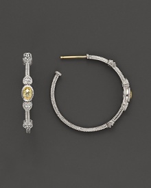 Faceted, oval-shaped canary crystals, flanked by hearts, bring romantic glamour to classic sterling silver hoop earrings. Faceted, oval-shaped canary crystals, flanked by hearts, bring romantic glamour to classic sterling silver hoop earrings.