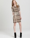 Stop traffic from commute to corner office in this Burberry Brit dress emblazoned by an oversized checked print for modern elegance.