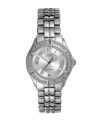 A traditional timepiece gets a glittering update by GUESS. Watch crafted of silver tone bracelet and round case. Bezel embellished with crystal accents. Textured silver tone dial features applied numerals at twelve, six and nine o'clock, date window at three o'clock, luminous hands and logo. Quartz movement. Water resistant to 100 meters.