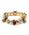 Slip some sweet style and sparkle over your wrists with this chic Betsey Johnson bracelet. Bracelet stretches to fit the wrist and features rows of round-cut crystal, flower and ribbon charms. Crafted in antique gold tone mixed metal. Approximate diameter: 2-1/4 inches.