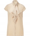 Elegant top in fine, almond silk - Button down style, with small, stand-up collar and short sleeves - The standout detail: chic ruffle flounce at chest - Slim cut close to the body, hits just below hip - Light darting at back and sides creates a streamlined silhouette - Go for a classic look with a pencil skirt and pumps, or pair with leather pants and ankle booties for an edgier appeal