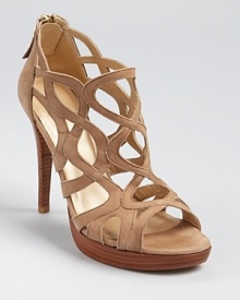 Oh-so-strappy--the Stuart Weitzman Noodling sandals offer a caged silhouette with feminine allure. Oh-so-strappy--the Stuart Weitzman Noodling sandals offer a caged silhouette with feminine allure.