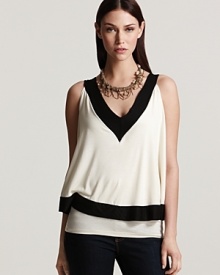 A layered Sweet Pea top boasts must-have color blocking, standing out in black and white for sharp, graphic style. A layered Sweet Pea top boasts must-have color blocking, standing out in black and white for sharp, graphic style.