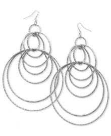 Style that runs circles around the competition. These orbital hoop earrings by GUESS are crafted in imitation rhodium tone mixed metal. Approximate drop: 4 inches. Approximate diameter: 3 inches.