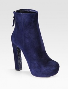 This ankle boot design features a glitter sole and hidden platform. Glitter and suede heel, 5¼ (130mm)Hidden platform, 1½ (40mm)Compares to a 3¾ heel (95mm)Suede upperBack zipGlitter soleLeather lining and solePadded insoleMade in Italy This ankle boot design features a glitter sole and hidden platform. Glitter and suede heel, 5¼ (130mm)Hidden platform, 1½ (40mm)Compares to a 3¾ heel (95mm)Suede upperBack zipGlitter soleLeather lining and solePadded insoleMade in Italy