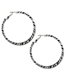 Answer the call of the wild. Bold zebra stripes in black enamel adorn this fierce hoop style from Style&co. Crafted in silver tone mixed metal. Approximate diameter: 2-1/4 inches. Answer the call of the wild. Bold zebra stripes in black enamel adorn this fierce hoop style from Style&co. Crafted in silver tone mixed metal. Approximate diameter: 2-1/4 inches.