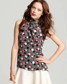 With vintage-chic inspiration in an eye-popping polka dot print, this sleeveless silk Milly top features a high collar finished with an oversized tie scarf and a just-right drape. With vintage-chic inspiration in an eye-popping polka dot print, this sleeveless silk Milly top features a high collar finished with an oversized tie scarf and a just-right drape.