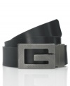 Add some instant edge to your jeans when you finish off your look with the oversized textured metal G of this sleek logo belt from GUESS.