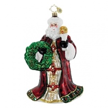 A regally dressed Santa holds a torch and festive wreath. A regally dressed Santa holds a torch and festive wreath.