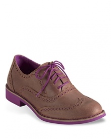 These not-so-basic Cole Haan flats are a funky take on the classic perforated oxford, with snappy pink accents that update the look. These not-so-basic Cole Haan flats are a funky take on the classic perforated oxford, with snappy pink accents that update the look.