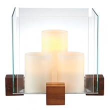 Create an artful showcase of candlelight and favorite objects displayed inside this striking piece from Dansk. In an elegant pairing of raw materials and minimalist design, blocks of richly grained wood support thick panes of sparkling clear glass. Create an artful showcase of candlelight and favorite objects displayed inside this striking piece from Dansk. In an elegant pairing of raw materials and minimalist design, blocks of richly grained wood support thick panes of sparkling clear glass.